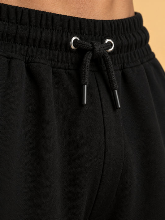 Black track pants drawstring waistband close-up
